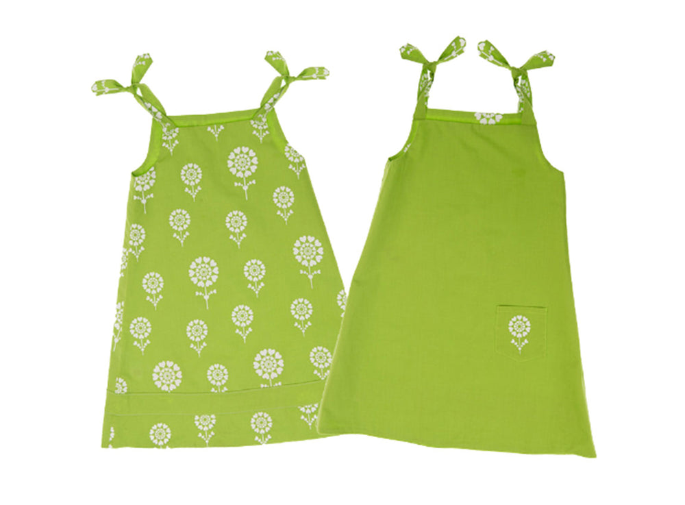 A green dress with a white floral design on one side and a small pocket with a white flower on the other side.