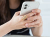 A girl wearing the brass  adjustable ring on her right index finger while using a smartphone.
