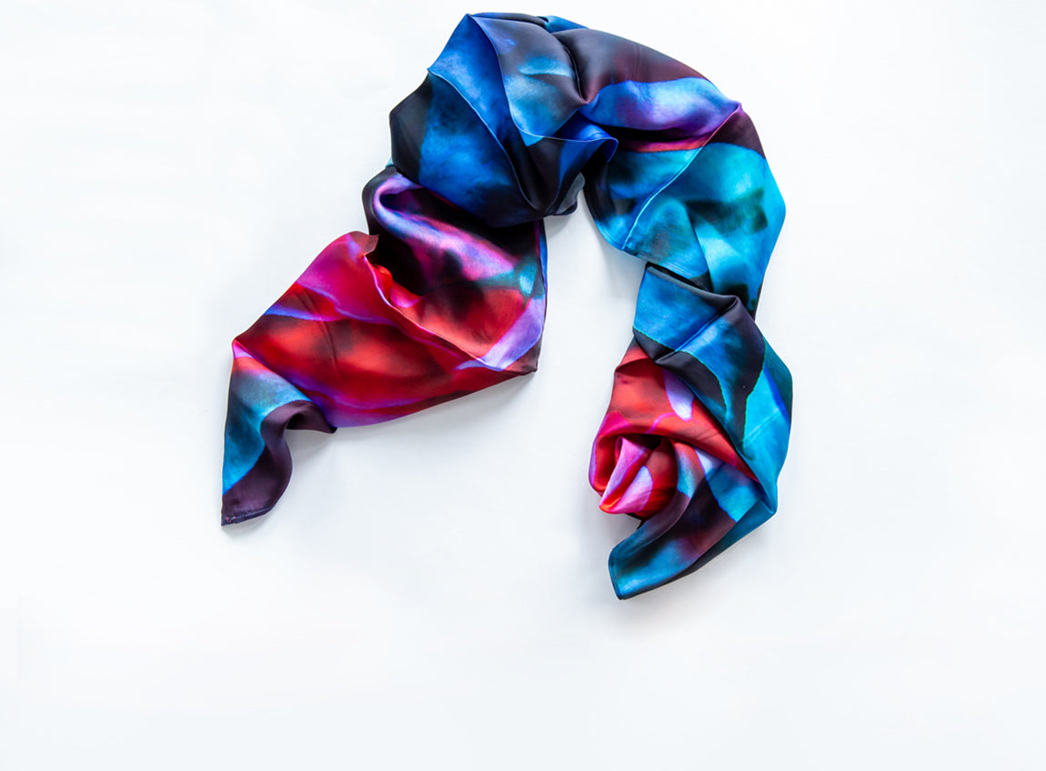 A multicolour satin scarf with shades of blue and pink.