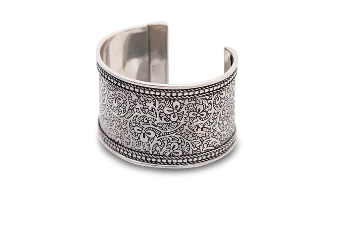 An adjustable silver cuff bracelet engraved with an Indian vine motif.